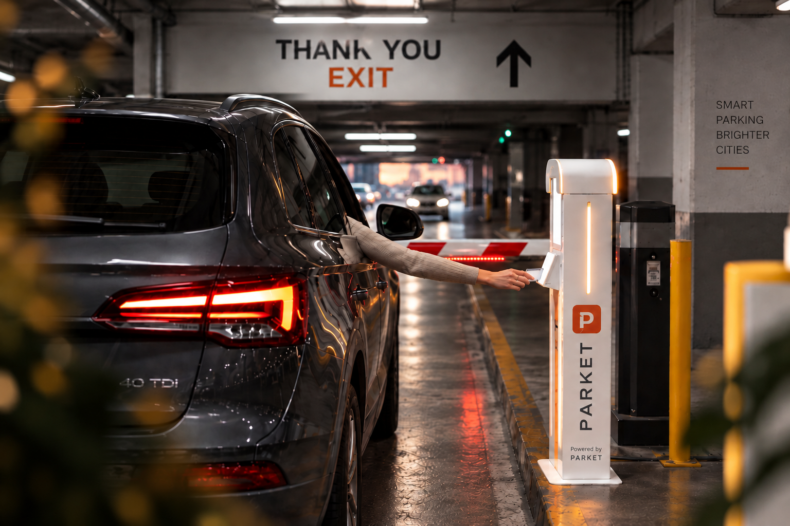 Parket access control: a driver taps the Parket kiosk at a parkade boom gate to exit, with thank-you exit signage overhead